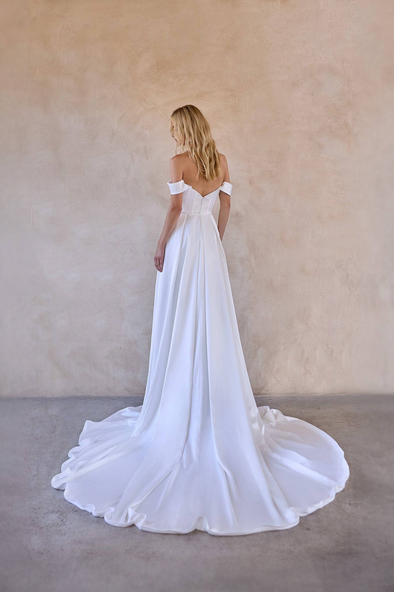 Full back image of the Jax mini satin wedding dress with detachable satin overskirt skirt. V back design detail and invisible zipper opening
