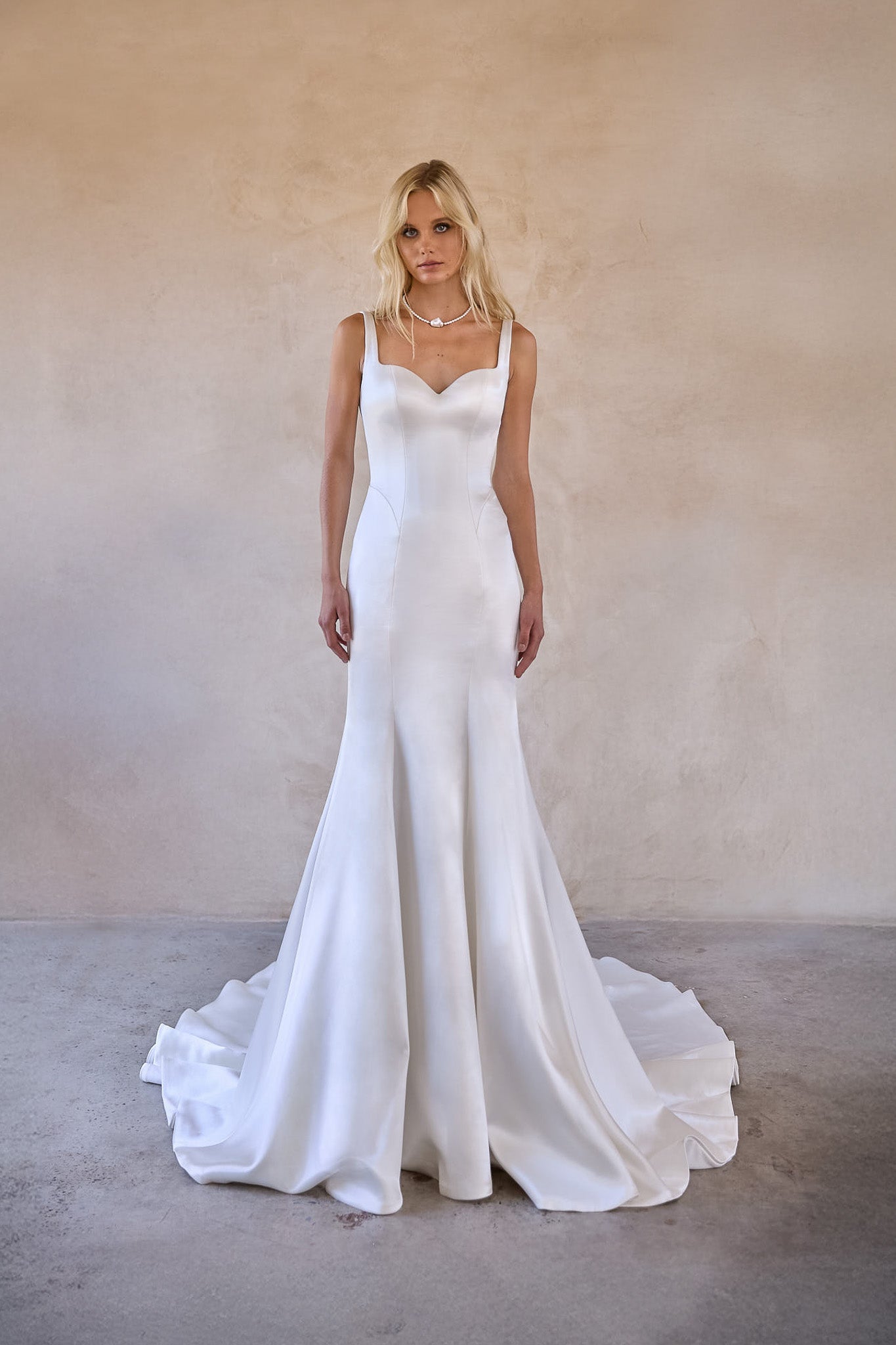 Luxurious satin fabric of The Bryd'es Jaya gown reflecting light beautifully.