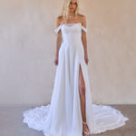 jessi is an off shoulder chiffon a-line wedding dress with thigh high split. ruched chiffon bodice with v waist design to enhance silhouette